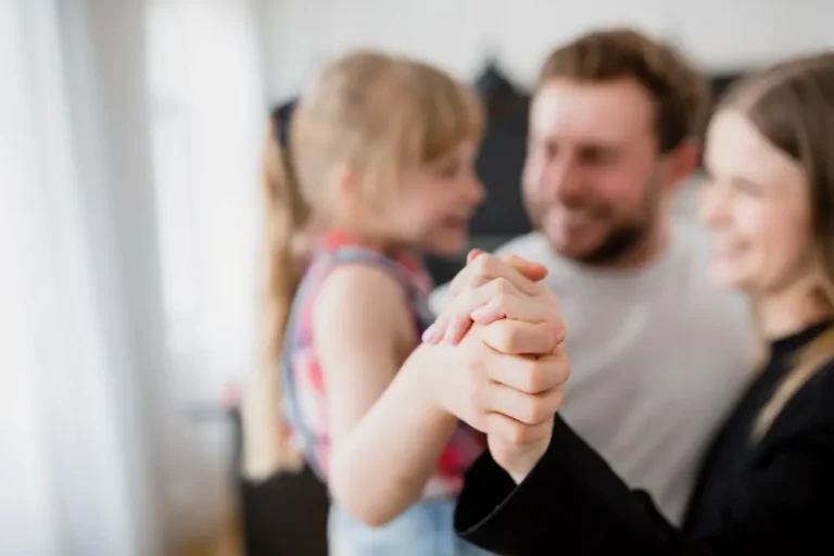 a girl holds the hands of her respectful parents